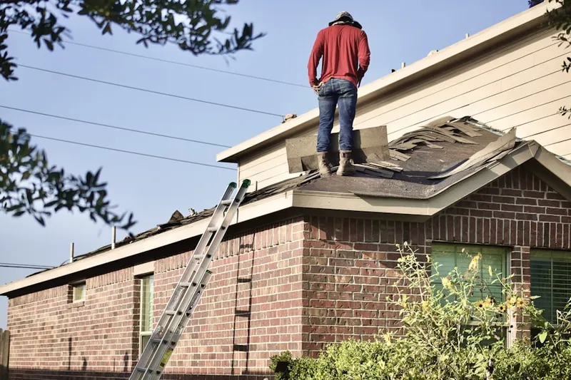 Professional roofer working on a residential roof in West Laurel Hill